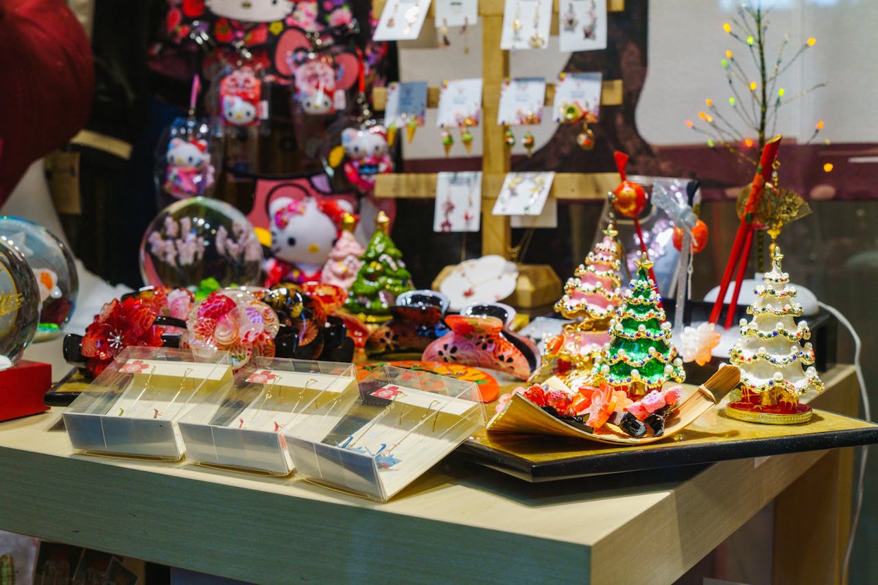 Colorful Christmas ornaments and Hello Kitty items in a festive shop display.